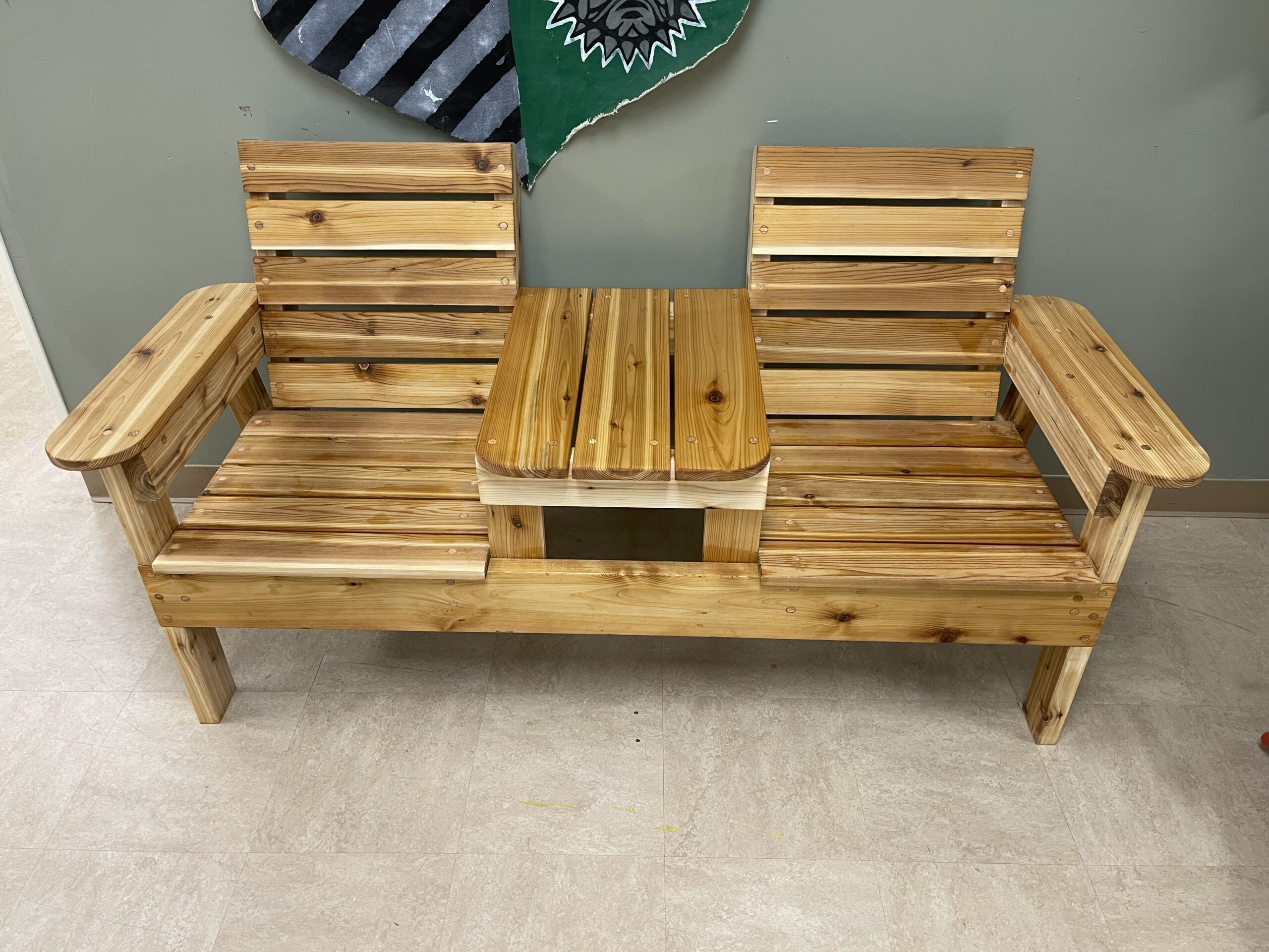 Handcrafted red cedar two-seat bench with inset table, custom outdoor furniture, weather-resistant patio seating.